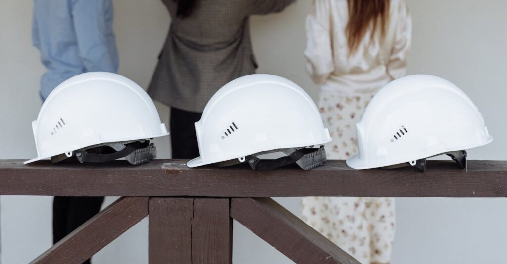 Group of architects discussing construction plans with hard hats in focus.